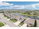Expansive aerial view of a home in a peaceful community, featuring a scenic lake with fountains at 16709 Barnwood Pl, Bradenton, FL 34211