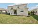 Home's back exterior with well-maintained lawn at 16709 Barnwood Pl, Bradenton, FL 34211