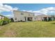 Home's back exterior and spacious yard offer relaxation and outdoor enjoyment at 16709 Barnwood Pl, Bradenton, FL 34211