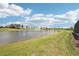 Scenic backyard view showcasing pond with fountain and expansive lawn at 16709 Barnwood Pl, Bradenton, FL 34211