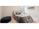 Bedroom with a padded headboard and ottoman seating at 16709 Barnwood Pl, Bradenton, FL 34211