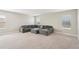 Upstairs bonus room featuring plush carpeting and a cozy sectional couch at 16709 Barnwood Pl, Bradenton, FL 34211