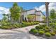 Attractive clubhouse with beautiful landscaping, featuring lush greenery and vibrant plants, providing a serene atmosphere at 16709 Barnwood Pl, Bradenton, FL 34211