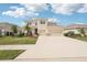 Charming two-story home featuring manicured lawn, lush landscaping, and a spacious three-car garage at 16709 Barnwood Pl, Bradenton, FL 34211