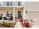 Inviting front porch with chairs and beautiful landscaping and tasteful stone accents at 16709 Barnwood Pl, Bradenton, FL 34211