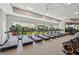 Well-equipped gym with state-of-the-art treadmills overlooking a scenic view of tropical landscaping at 16709 Barnwood Pl, Bradenton, FL 34211