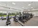 Bright gym features modern exercise equipment with large windows offering refreshing outdoor views at 16709 Barnwood Pl, Bradenton, FL 34211