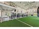 Modern gym with high ceilings and a variety of exercise equipment including an indoor football field at 16709 Barnwood Pl, Bradenton, FL 34211