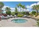 Relaxing hot tub area surrounded by lush landscaping and comfortable lounge chairs for a serene outdoor experience at 16709 Barnwood Pl, Bradenton, FL 34211