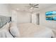 Cozy primary bedroom with ceiling fan, en suite bathroom, and flat-screen television at 16709 Barnwood Pl, Bradenton, FL 34211
