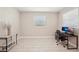 Large room with neutral walls, tile flooring, and natural light, ideal for an office at 16709 Barnwood Pl, Bradenton, FL 34211