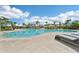 Stunning pool area with clear blue water, palm trees, and comfortable lounge chairs for relaxation in a tropical setting at 16709 Barnwood Pl, Bradenton, FL 34211