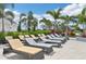 Lounge chairs by a sparkling pool with lush landscaping providing a resort-like atmosphere for ultimate relaxation at 16709 Barnwood Pl, Bradenton, FL 34211