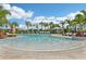 Beautiful pool featuring lounge chairs, cabanas, palm trees, and clear blue water, perfect for relaxation and recreation at 16709 Barnwood Pl, Bradenton, FL 34211