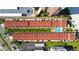 Aerial view of condo complex with swimming pool, lush landscaping, and ample parking at 17960 Gulf Blvd # 104, Redington Shores, FL 33708