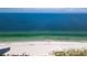 Expansive aerial view of crystal-clear ocean waters and sandy beach, offering coastal living experience at 17960 Gulf Blvd # 104, Redington Shores, FL 33708