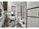 Modern bathroom featuring dual vessel sinks, granite countertop, tub with shower, and dark tile floor at 17960 Gulf Blvd # 104, Redington Shores, FL 33708
