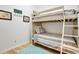 Neutral-toned bedroom with a bunk bed, bright light, and decor at 17960 Gulf Blvd # 104, Redington Shores, FL 33708