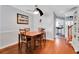 Dining area with hardwood floors and space for a table and chairs, adjacent to kitchen at 17960 Gulf Blvd # 104, Redington Shores, FL 33708