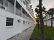 Exterior of the condo showing clean white facade, private balconies, and landscaping at 17960 Gulf Blvd # 104, Redington Shores, FL 33708