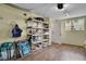 Well-organized garage with shelving for storage, textured floors, and an exterior door at 17960 Gulf Blvd # 104, Redington Shores, FL 33708