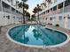 Resort-style condo complex with a sparkling pool in the courtyard at 17960 Gulf Blvd # 104, Redington Shores, FL 33708