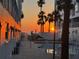 Picturesque sunset view, showcasing palm trees near a pool, perfect place to unwind at 17960 Gulf Blvd # 104, Redington Shores, FL 33708