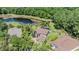 Aerial view of the home with a private pool surrounded by lush greenery and a pond at 19139 Cypress Reach Ln, Tampa, FL 33647