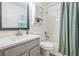 Well-lit bathroom with a shower-tub combo, cabinet storage, and modern sink at 19139 Cypress Reach Ln, Tampa, FL 33647