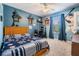 Bedroom painted in light blue, baseball themed decorations and bright natural light at 19139 Cypress Reach Ln, Tampa, FL 33647