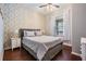 Cozy bedroom with stylish accent wall, ceiling fan, and bright natural light at 19139 Cypress Reach Ln, Tampa, FL 33647