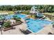 Community pool featuring a slide, lap pool, and ample seating at 19139 Cypress Reach Ln, Tampa, FL 33647