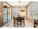 Casual dining area with sliding glass door leading to pool, pendant lighting and seating for four at 19139 Cypress Reach Ln, Tampa, FL 33647