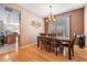 Formal dining room with hardwood floors, a decorative chandelier, and a view to the kitchen at 19139 Cypress Reach Ln, Tampa, FL 33647