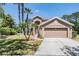 Beautiful two-story home featuring well-manicured lawn, a two-car garage, and mature palm trees at 19139 Cypress Reach Ln, Tampa, FL 33647