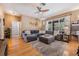 Comfortable living room with a large sectional sofa, hardwood floors, and view of the outdoor space at 19139 Cypress Reach Ln, Tampa, FL 33647