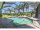 Screened-in pool featuring tile accents, outdoor seating, and serene backyard views at 19139 Cypress Reach Ln, Tampa, FL 33647