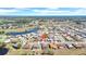 Great aerial view of home in quiet residential neighborhood with mature trees and nearby lake at 1969 Wolf Laurel Dr, Sun City Center, FL 33573