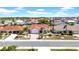 Aerial view of this home with manicured lawn, mature palms, and a red tiled roof at 1969 Wolf Laurel Dr, Sun City Center, FL 33573