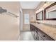 Bathroom features a double sink vanity with granite countertops and tile flooring at 1969 Wolf Laurel Dr, Sun City Center, FL 33573