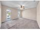 Spacious bedroom featuring neutral carpet, dual windows, and a ceiling fan for comfortable living at 1969 Wolf Laurel Dr, Sun City Center, FL 33573
