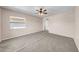 Bedroom with neutral carpet, ceiling fan, and a window for natural light at 1969 Wolf Laurel Dr, Sun City Center, FL 33573