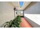Hallway featuring skylights, decorative plants, a neutral color scheme, and tile flooring at 1969 Wolf Laurel Dr, Sun City Center, FL 33573