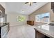 Bright kitchen featuring tiled floors, granite countertops, and ample natural light from two windows at 1969 Wolf Laurel Dr, Sun City Center, FL 33573