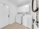 Laundry room with side-by-side white washer and dryer at 1969 Wolf Laurel Dr, Sun City Center, FL 33573