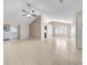 Bright living room with tile flooring, a sliding glass door, and an open layout for easy entertaining at 1969 Wolf Laurel Dr, Sun City Center, FL 33573