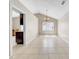 Bright living area with tile floors, vaulted ceiling, chandelier, and a doorway providing a glimpse of the kitchen at 1969 Wolf Laurel Dr, Sun City Center, FL 33573