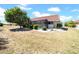 View of home's exterior with rear lanai, luscious lawn, and beautiful tropical landscaping at 1969 Wolf Laurel Dr, Sun City Center, FL 33573