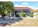 Home's exterior featuring rear lanai, landscaped yard and beautiful red tiled roof at 1969 Wolf Laurel Dr, Sun City Center, FL 33573