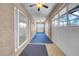 Sunroom featuring sliding glass doors, windows, ceiling fans, and blue carpeting at 1969 Wolf Laurel Dr, Sun City Center, FL 33573